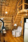 View of stairs to loft in log cabins.